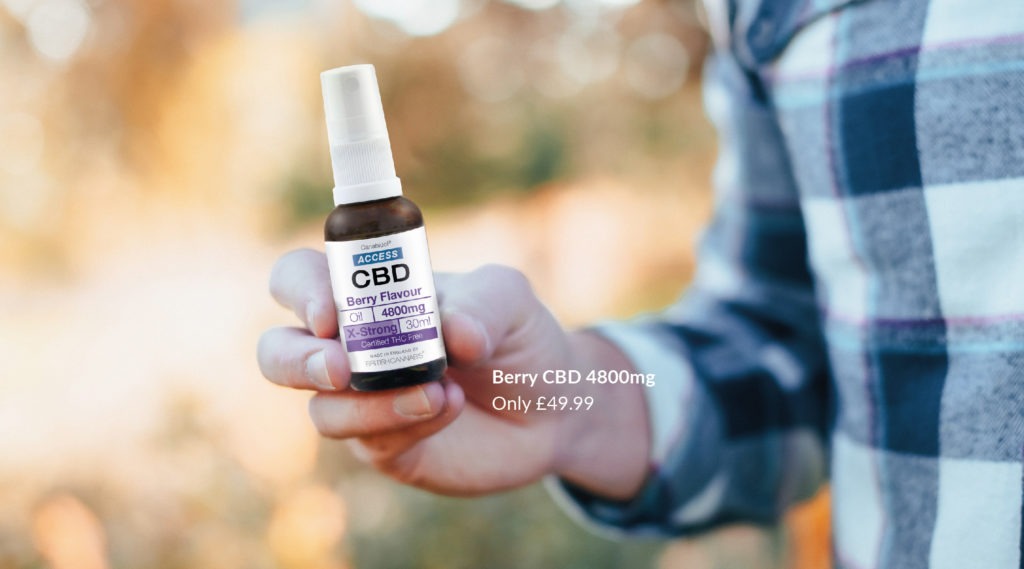 Man holding Berry Flavoured CBD oil, voted Best CBD Product 2020.