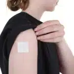 Image showing an ACCESS CBD Dermal Patch applied to the inner part of a person's arm, emphasizing its comfortable placement.