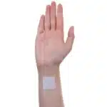 Image of an ACCESS CBD Dermal Patch on a person's arm, demonstrating how easily it blends with the skin.