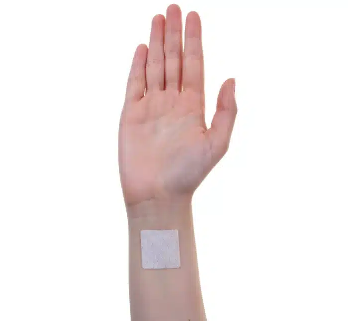 Image of an ACCESS CBD Dermal Patch on a person's arm, demonstrating how easily it blends with the skin.